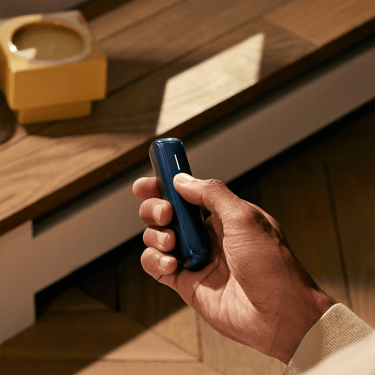 The Ploom AURA Navy Blue is a sleek and convenient device easy to hold
