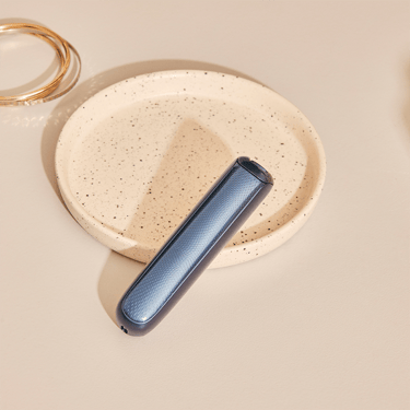 Ploom AURA front panels with Navy Blue Augmented Pattern placed on a table.