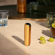 Ploom device with Mango Sorbet Back Cover standing on a table
