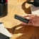 Hand showing a Jet Black Back Cover on a Ploom AURA device

