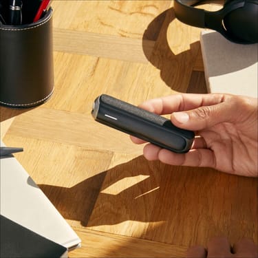 Hand showing a Jet Black Back Cover on a Ploom AURA device
