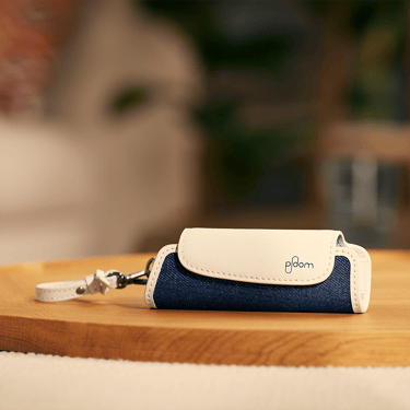 Ploom AURA Denim Leather Fusion Solo Carry Case accessory on a table
