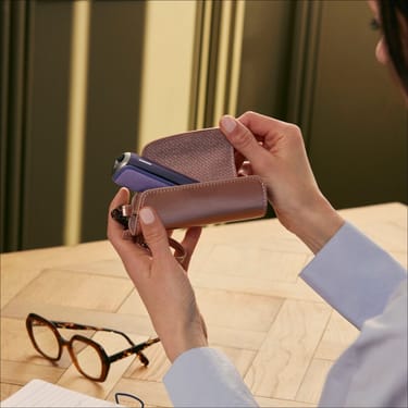 User opening a Ploom Solo Carry Case Rose Gold accessory