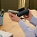 User removing a Ploom AURA device from the Solo Carry Case Jet Black accessory