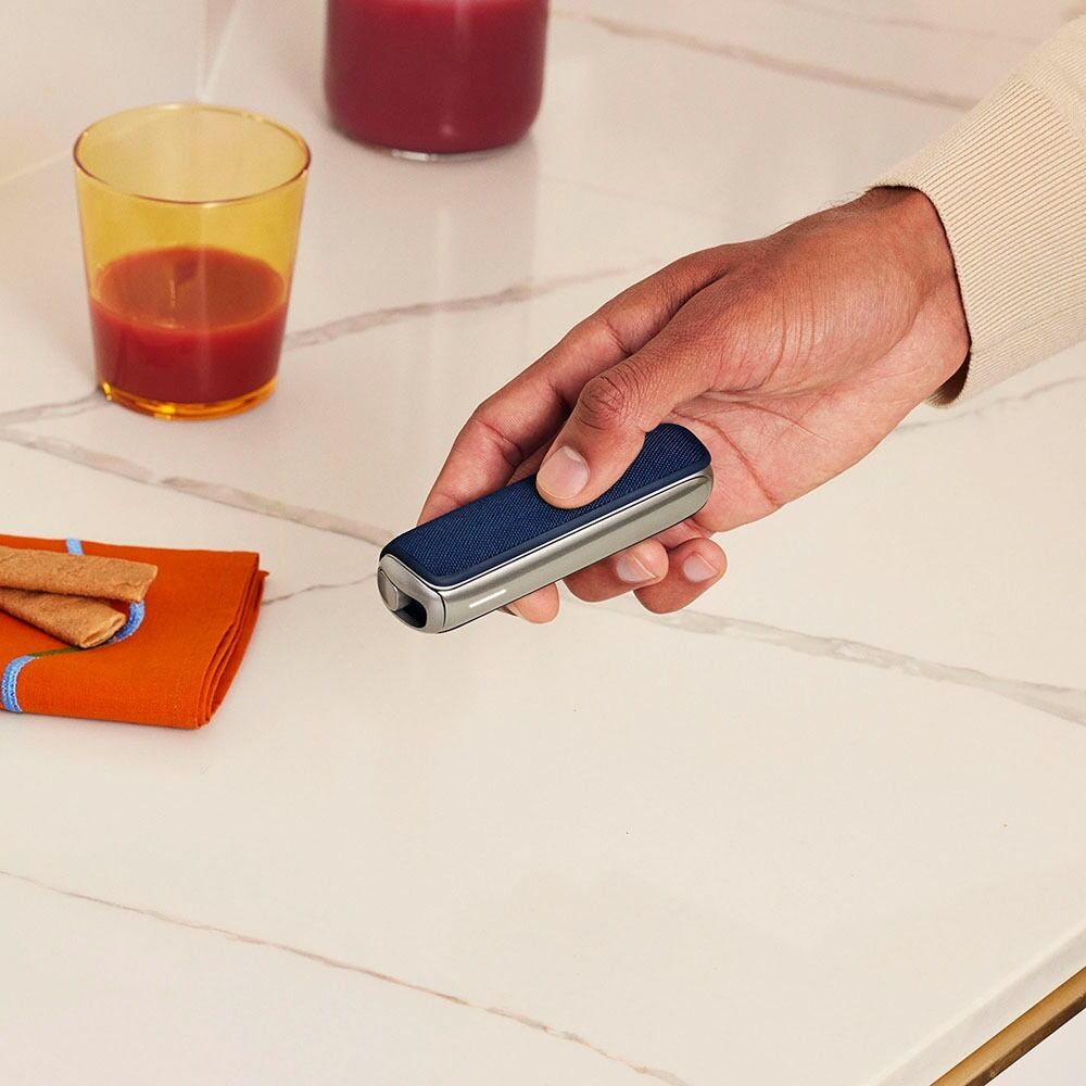 Hand holding Ploom device with Navy Blue Back Cover
